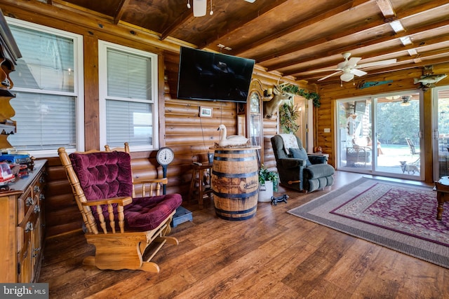 interior space with ceiling fan and beamed ceiling