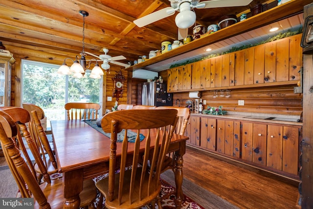 dining area with log walls, beamed ceiling, dark wood-type flooring, and ceiling fan with notable chandelier