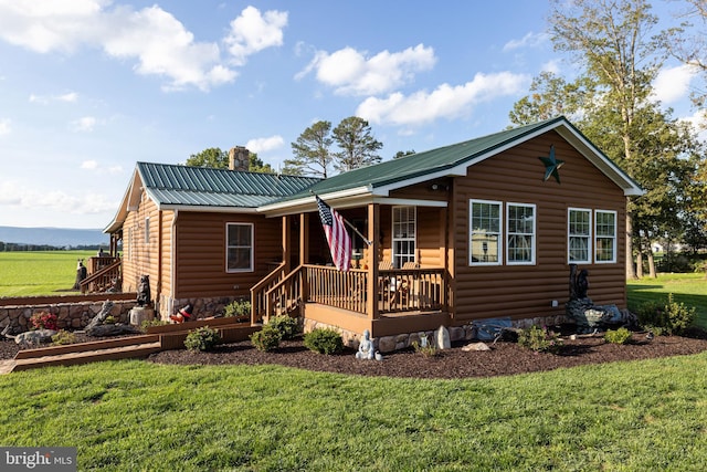 log cabin with a front yard