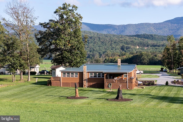 exterior space with a mountain view and a lawn