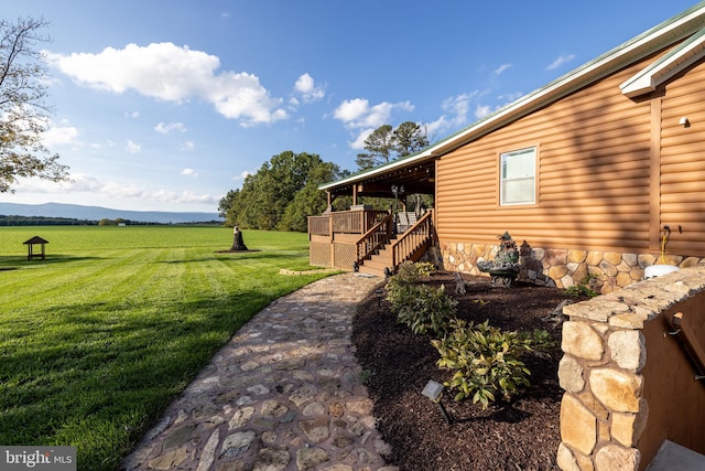 view of yard with a rural view and a mountain view