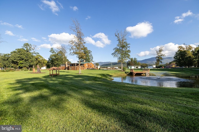 view of yard featuring a water and mountain view