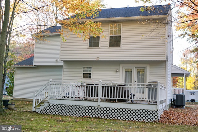 rear view of house featuring central air condition unit and a wooden deck