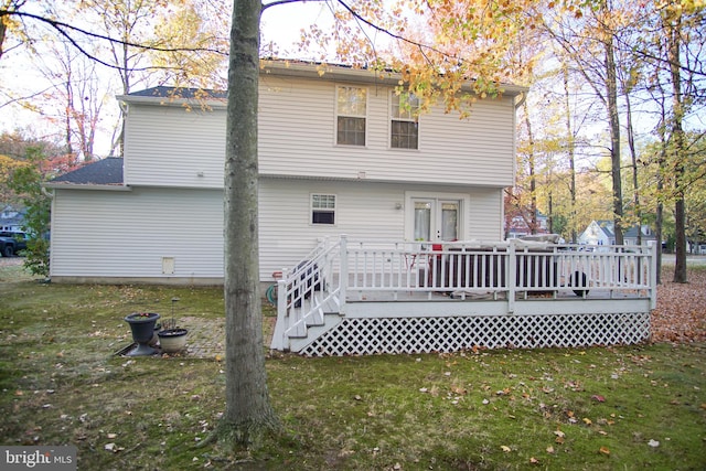 rear view of house with a yard and a deck