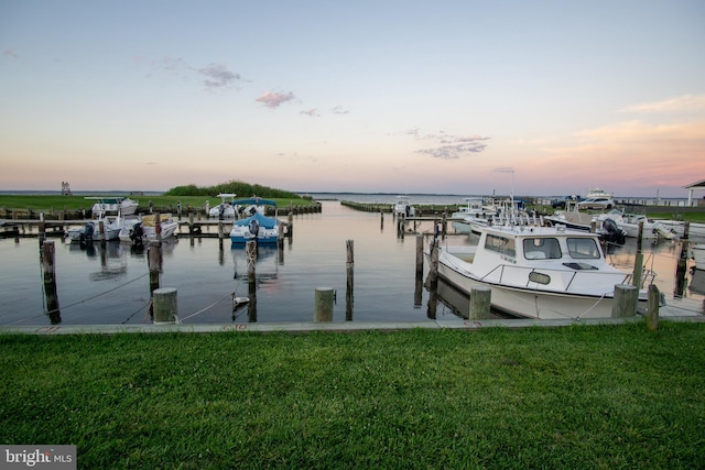 view of dock with a water view and a yard