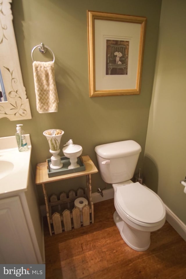 608 Cloverfields Dr, Stevensville, MD 21666 - bathroom featuring toilet, wood finished floors, vanity, and baseboards