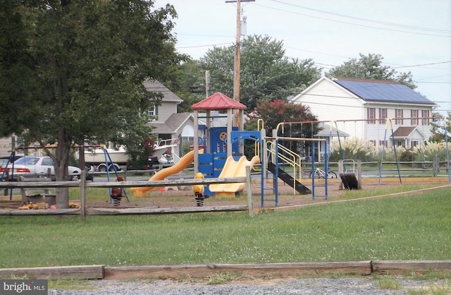 view of playground with a lawn