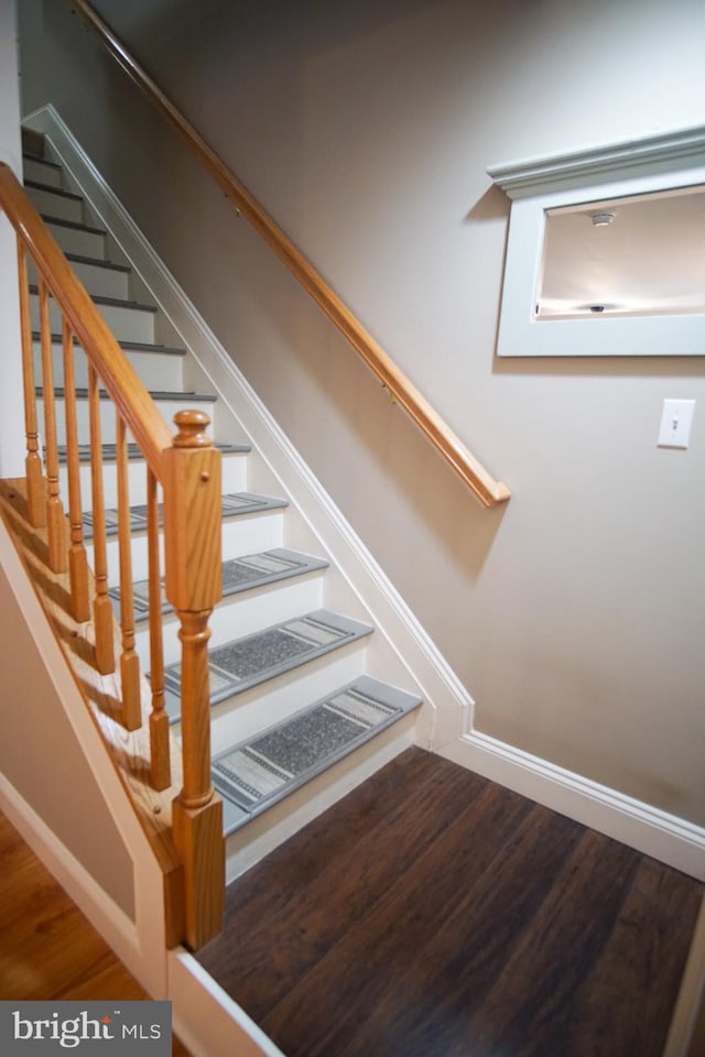 stairs with wood-type flooring