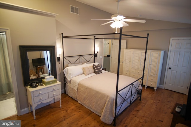 bedroom with lofted ceiling, dark hardwood / wood-style floors, and ceiling fan