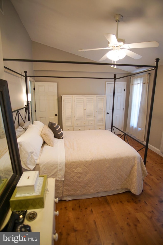 bedroom featuring hardwood / wood-style flooring, vaulted ceiling, and ceiling fan