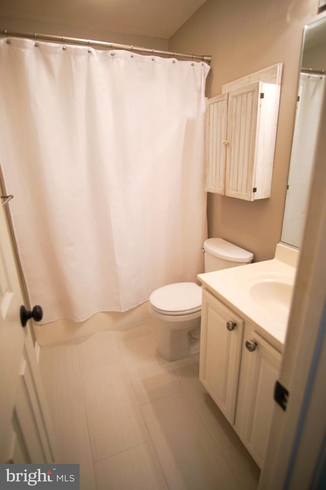608 Cloverfields Dr, Stevensville, MD 21666 - bathroom featuring vanity, toilet, tile patterned floors, and shower / bathtub combination with curtain