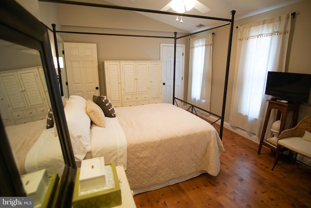 bedroom with ceiling fan, hardwood / wood-style flooring, and lofted ceiling