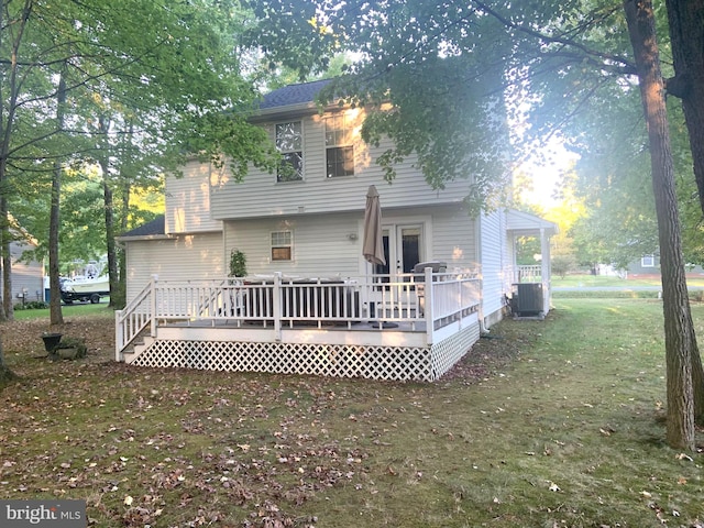 rear view of house with a wooden deck, a yard, and central air condition unit