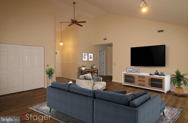 living area with visible vents, baseboards, a ceiling fan, and dark wood finished floors