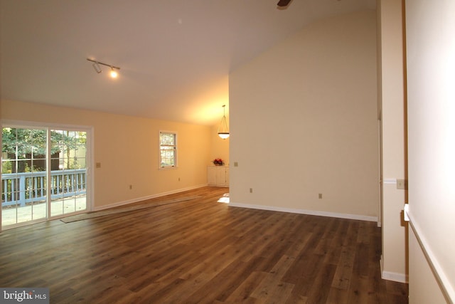 empty room with dark wood-type flooring, ceiling fan, baseboards, and lofted ceiling