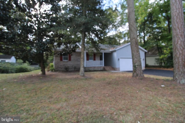 ranch-style home with a garage and a front lawn