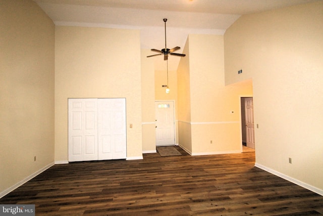 unfurnished room featuring ceiling fan, dark hardwood / wood-style flooring, and vaulted ceiling