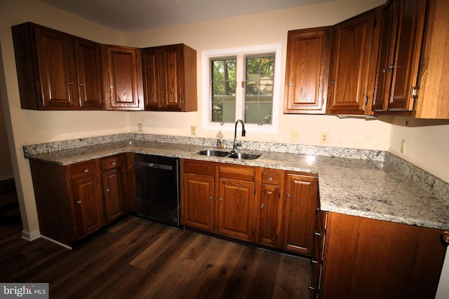 kitchen featuring dishwasher, dark hardwood / wood-style floors, light stone counters, and sink