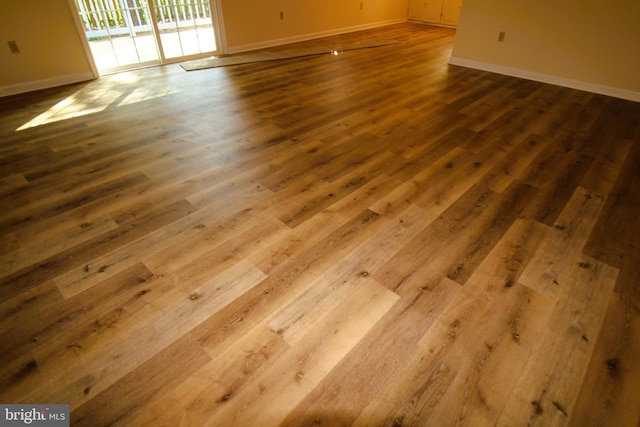 interior space with baseboards and dark wood-style flooring