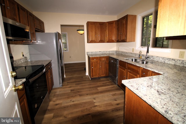 kitchen featuring light stone countertops, sink, black appliances, and dark hardwood / wood-style floors