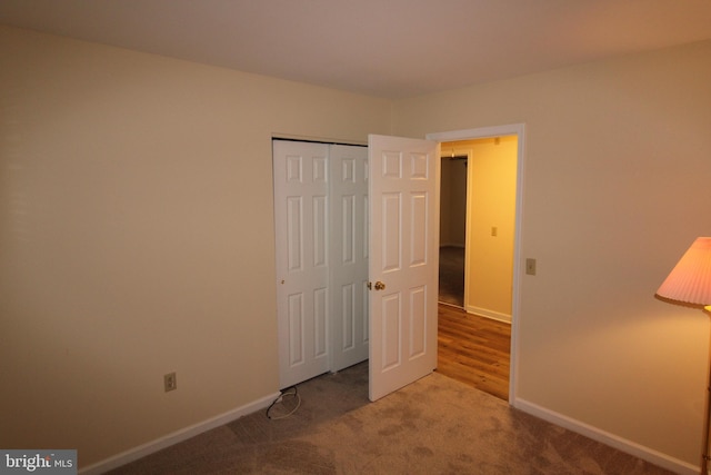 unfurnished bedroom with carpet and a closet