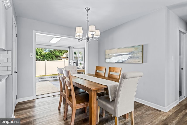 dining room featuring dark wood-type flooring and a notable chandelier