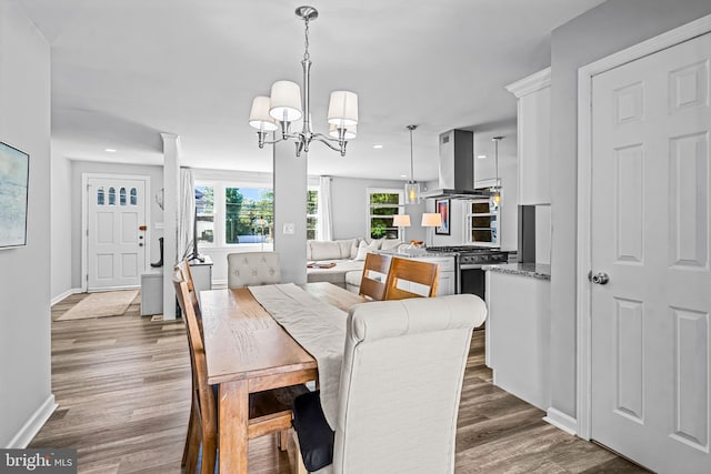 dining area featuring an inviting chandelier and dark wood-type flooring