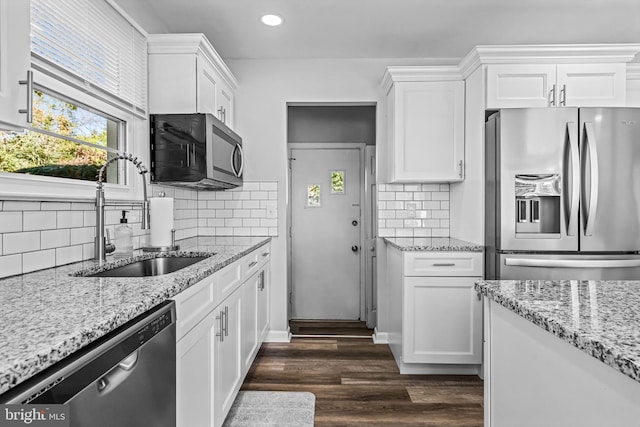 kitchen with appliances with stainless steel finishes, dark wood-type flooring, sink, and white cabinetry