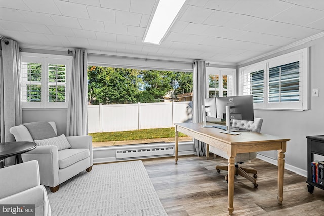 office area featuring crown molding, a wealth of natural light, a baseboard radiator, and hardwood / wood-style floors