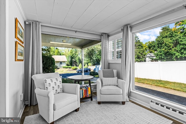 sunroom / solarium featuring baseboard heating