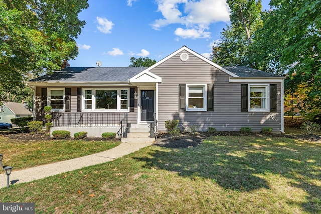 view of front of home with a porch and a front yard