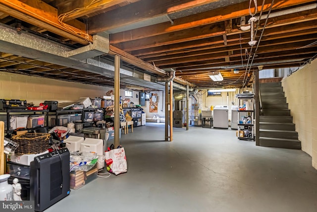 basement featuring separate washer and dryer and sink