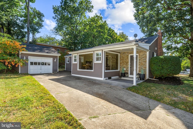 view of front of home with a front yard and a garage