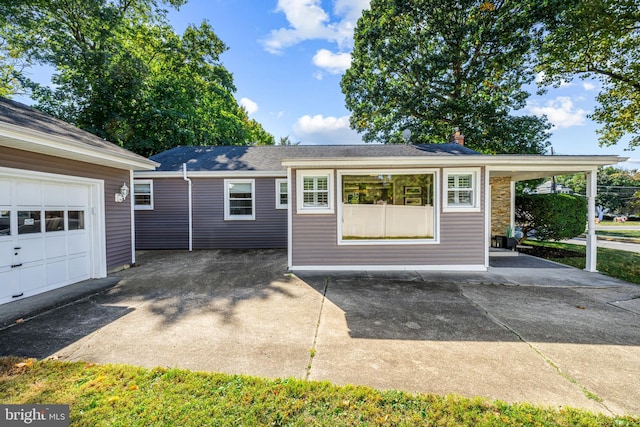 view of front facade featuring a carport and a garage