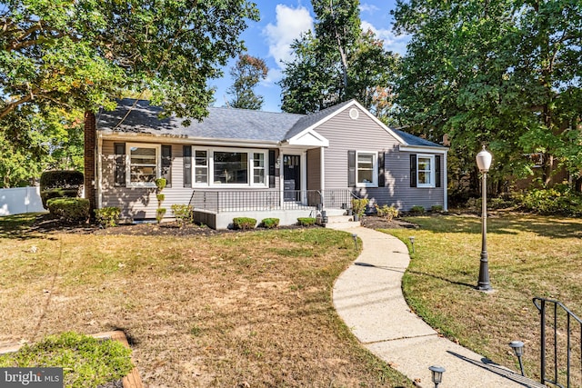 single story home featuring a front lawn and covered porch