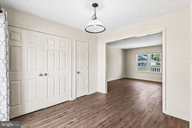 unfurnished dining area with dark hardwood / wood-style flooring