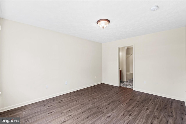 empty room with dark hardwood / wood-style floors