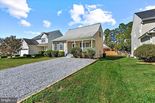 view of front of house featuring central AC, covered porch, and a front yard