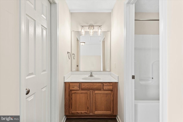 bathroom featuring a shower and vanity