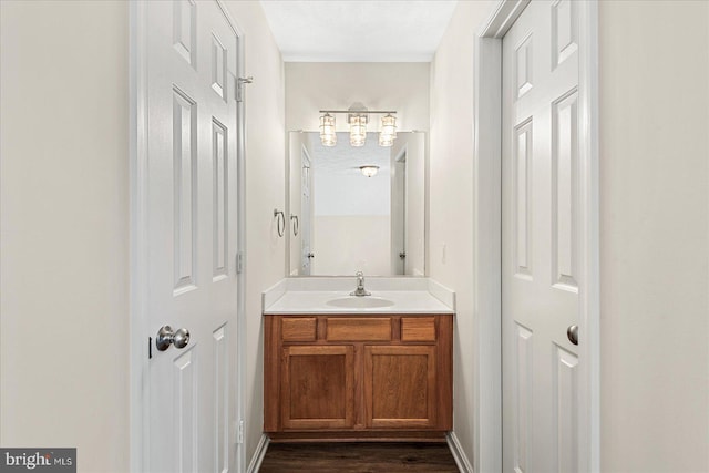 bathroom with hardwood / wood-style floors and vanity