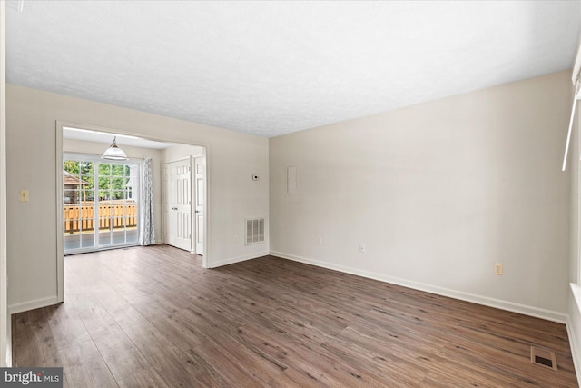 unfurnished living room with dark hardwood / wood-style flooring