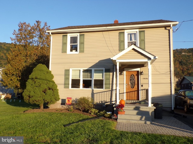 view of property featuring a front lawn