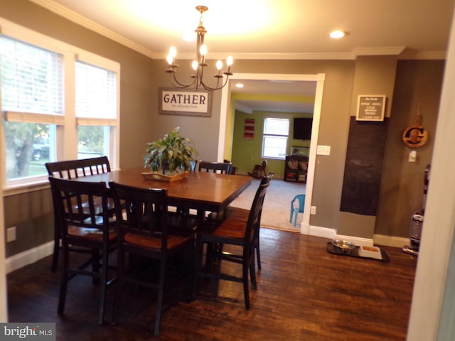 dining space with ornamental molding, a notable chandelier, and dark hardwood / wood-style flooring