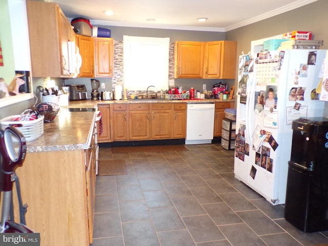 kitchen with dark tile patterned floors, ornamental molding, sink, and white appliances