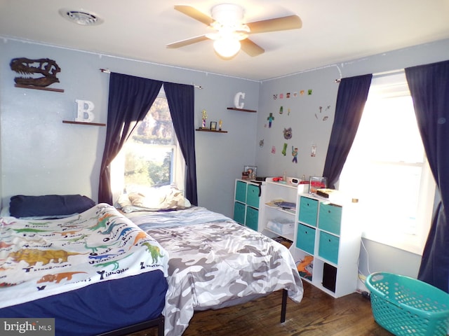 bedroom with hardwood / wood-style flooring and ceiling fan