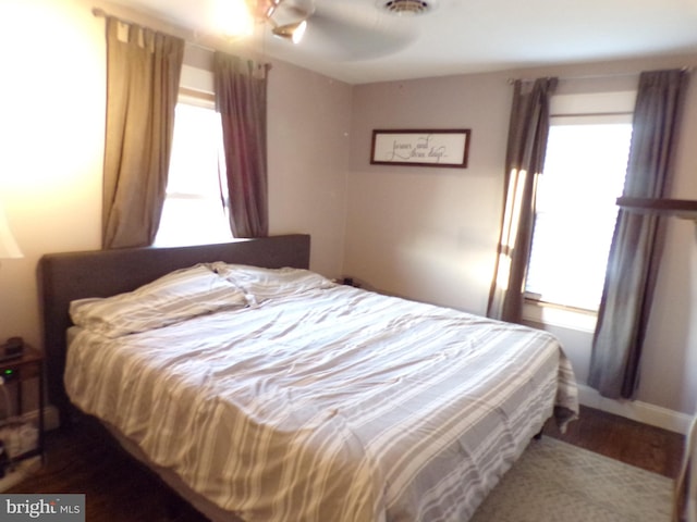 bedroom featuring ceiling fan and multiple windows