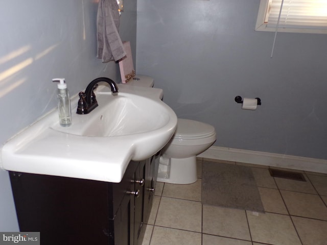 bathroom with vanity, toilet, and tile patterned flooring