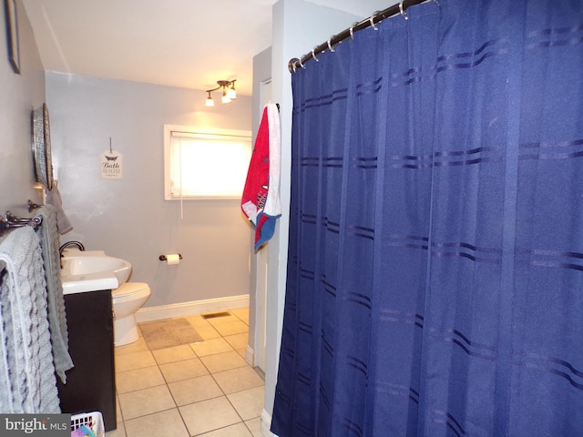 bathroom with vanity, curtained shower, toilet, and tile patterned flooring