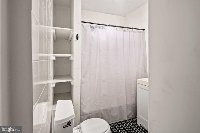 bathroom featuring a shower with curtain and toilet