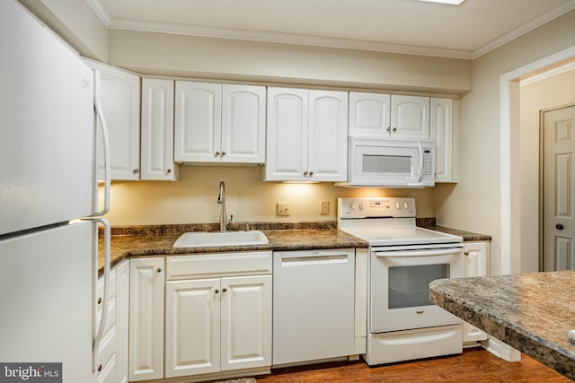 kitchen with sink, white cabinets, a textured ceiling, and white appliances